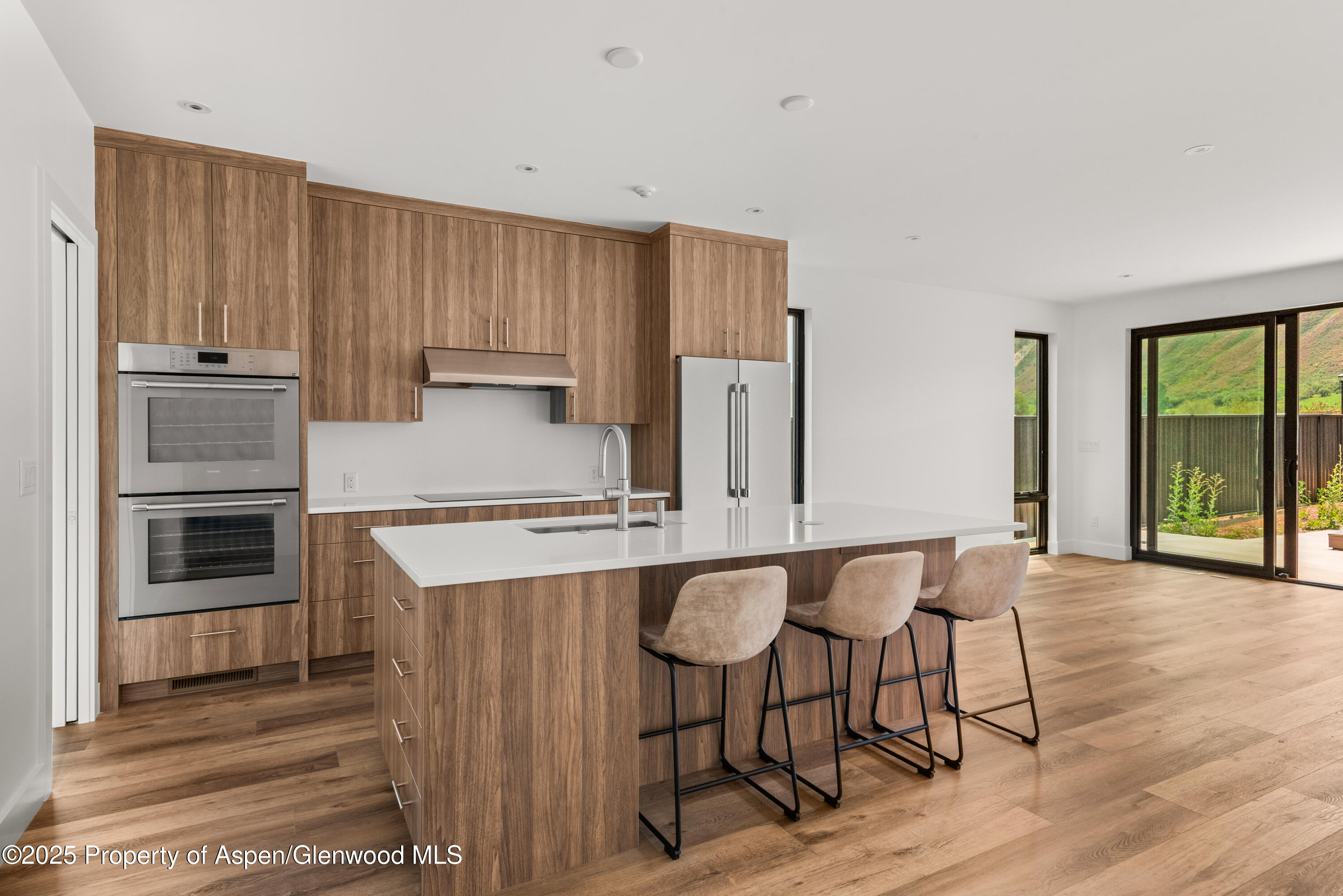 357 Stotts Mill Road Basalt, CO 81621 - Photo 14 of 29 a kitchen with stainless steel appliances granite countertop a stove top oven a sink and white cabinets
