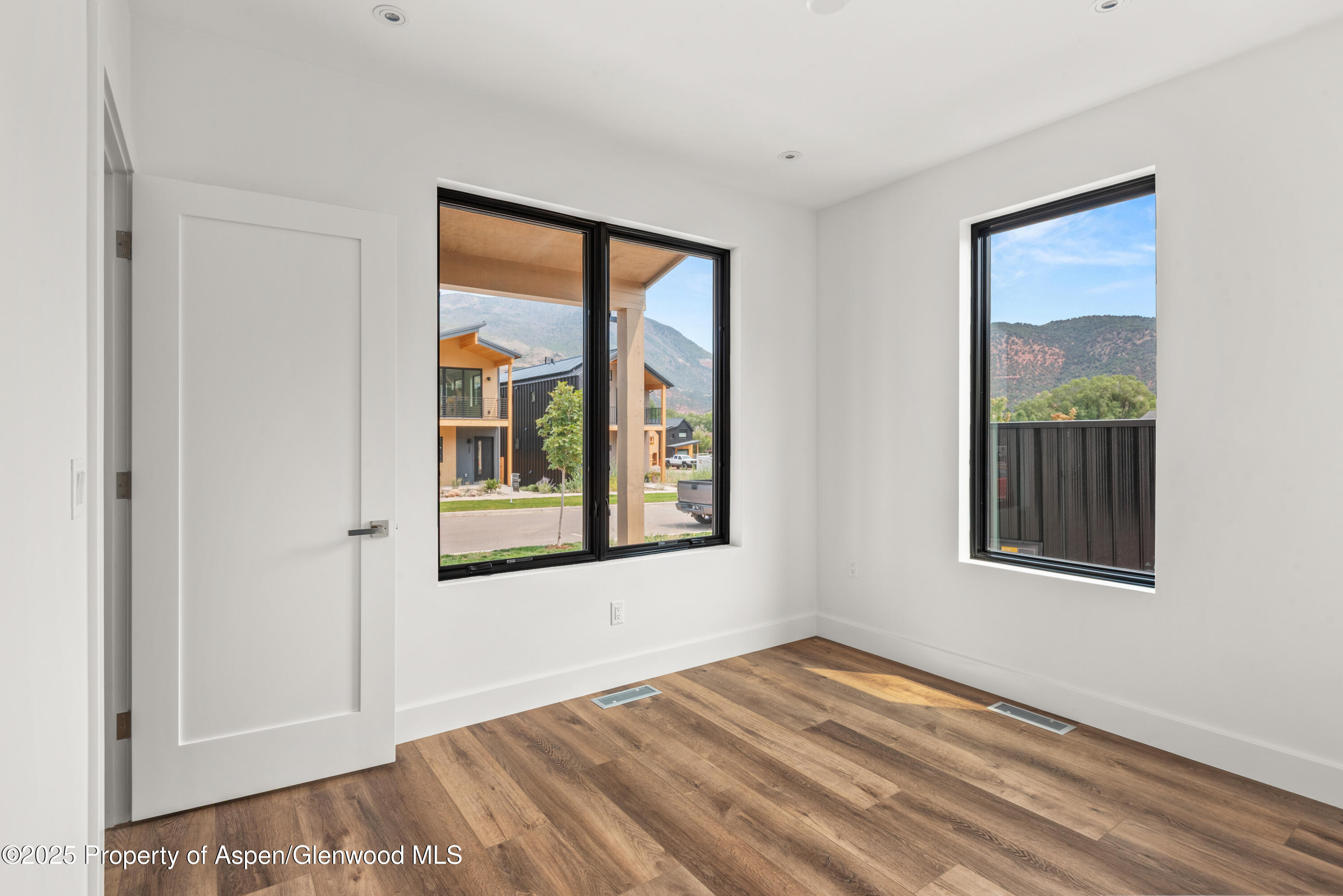 357 Stotts Mill Road Basalt, CO 81621 - Photo 15 of 29 a view of an empty room with a window and wooden floor