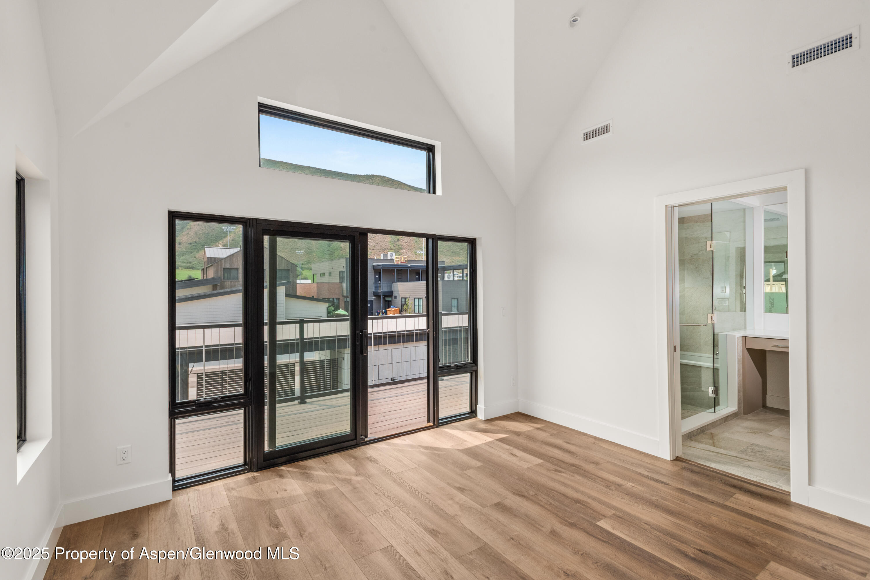 357 Stotts Mill Road Basalt, CO 81621 - Photo 17 of 29 a view of an empty room with wooden floor and a window