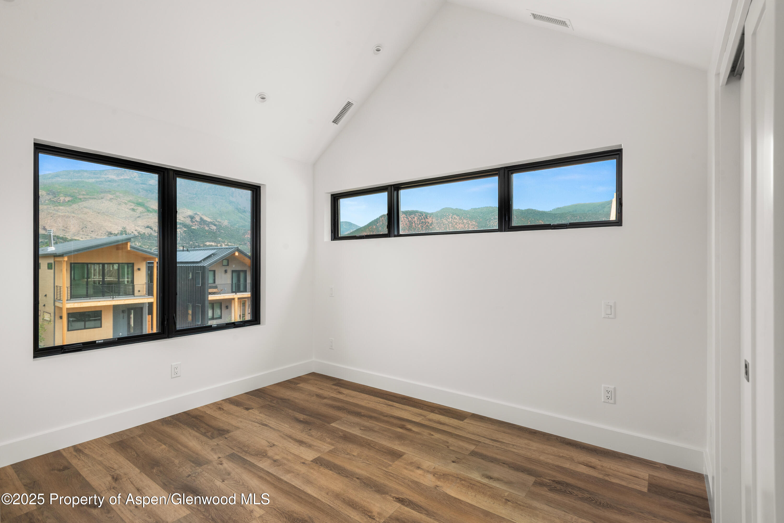 357 Stotts Mill Road Basalt, CO 81621 - Photo 22 of 29 a view of an empty room with wooden floor and a window