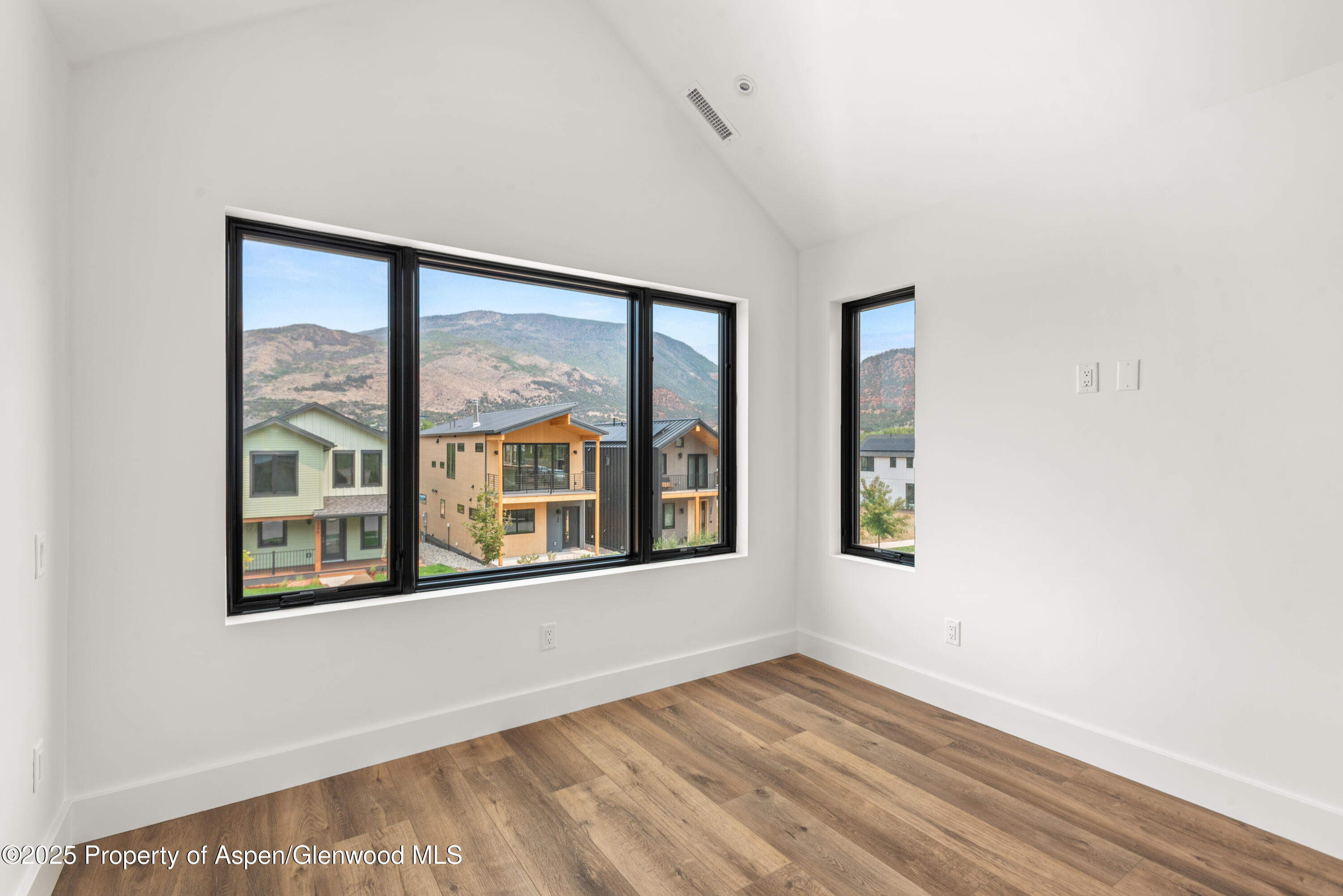 357 Stotts Mill Road Basalt, CO 81621 - Photo 23 of 29 an empty room with wooden floor and windows