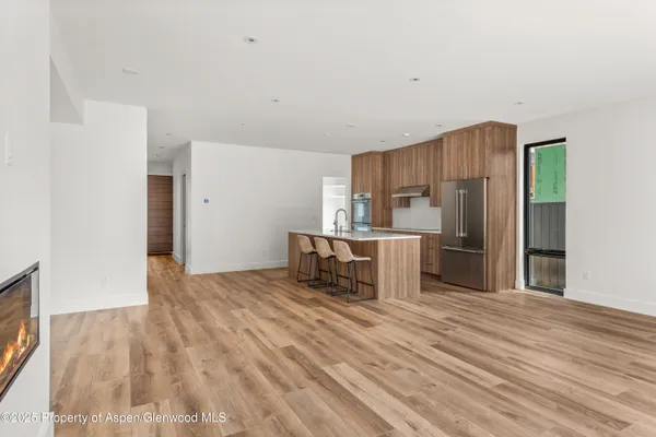 a kitchen with stainless steel appliances a refrigerator and a stove top oven