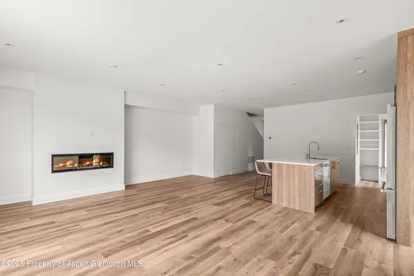 a room with a wooden floor and white walls