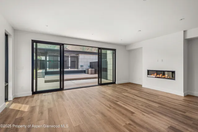 a view of an empty room with glass door