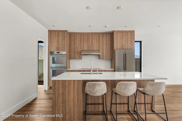 a kitchen with kitchen island granite countertop a table and chairs