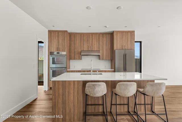 a kitchen with kitchen island granite countertop a table and chairs