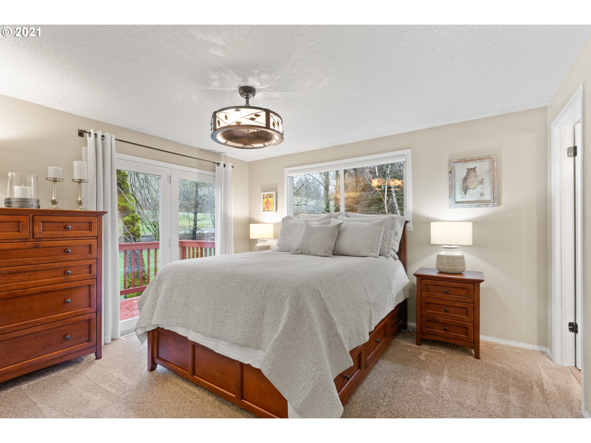 716 Northeast Evans Road Corbett, OR 97019 - Photo 22 of 32 a bedroom with a bed and a chandelier