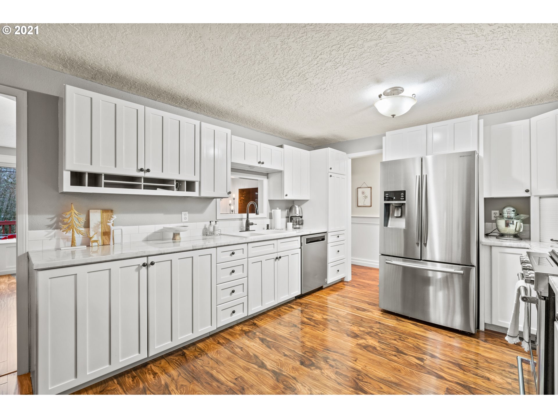 716 Northeast Evans Road Corbett, OR 97019 - Photo 8 of 32 a kitchen with granite countertop white cabinets and stainless steel appliances