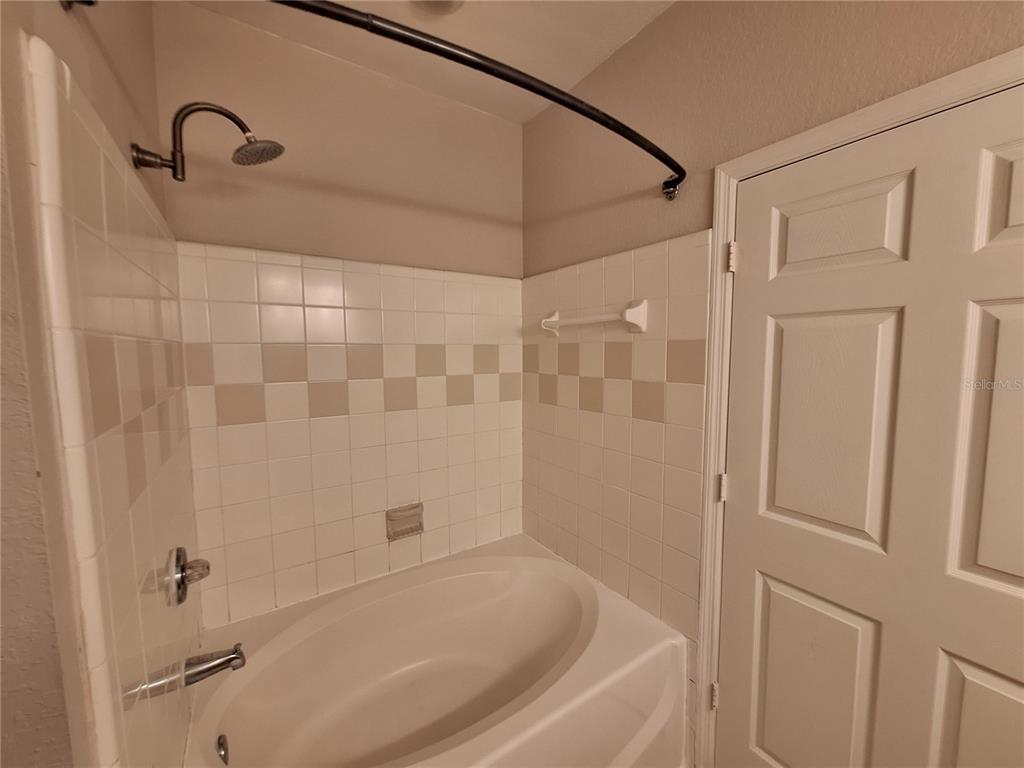 5550 Rosehill Road, Unit 103 Sarasota, FL 34233 - Photo 13 of 28 a bathroom with a shower and a bath tub