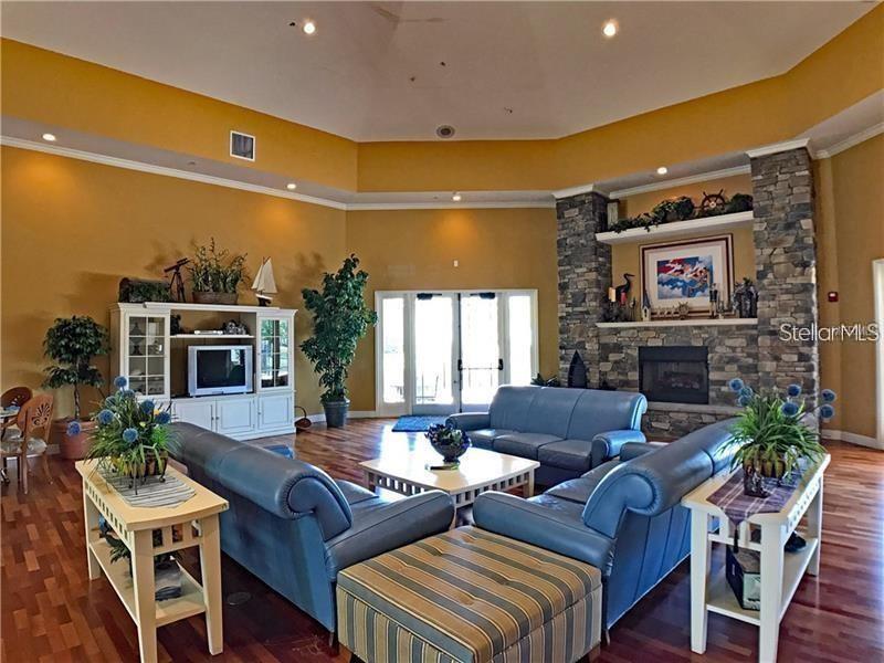 5550 Rosehill Road, Unit 103 Sarasota, FL 34233 - Photo 25 of 28 a living room with fireplace furniture and a flat screen tv