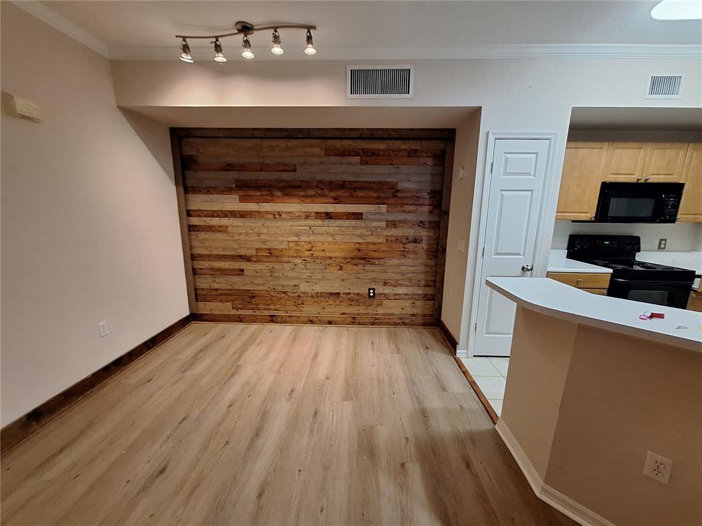 5550 Rosehill Road, Unit 103 Sarasota, FL 34233 - Photo 6 of 28 a living room with hard wood floors and a fireplace