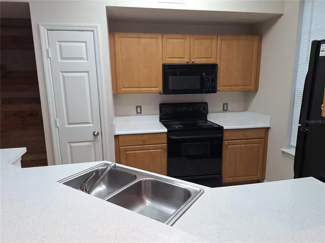 a kitchen with a refrigerator sink and microwave