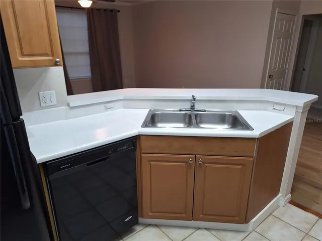 a kitchen with a sink and a mirror