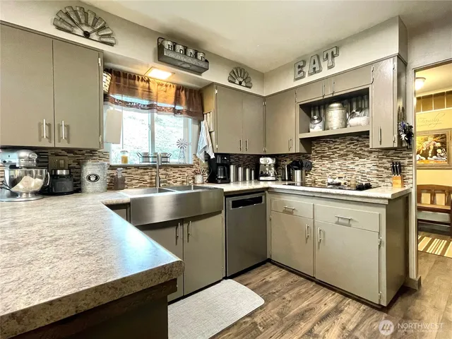 a kitchen with a sink stove and cabinets