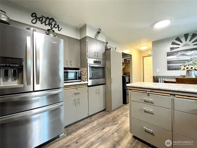 a kitchen with a refrigerator and a sink