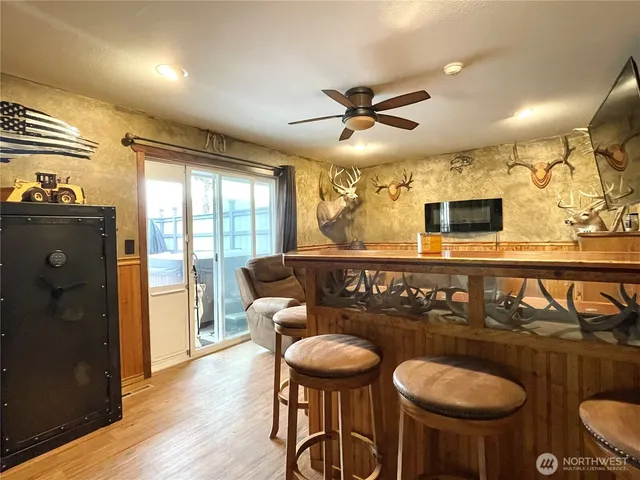 a living room with furniture a flat screen tv and a large window