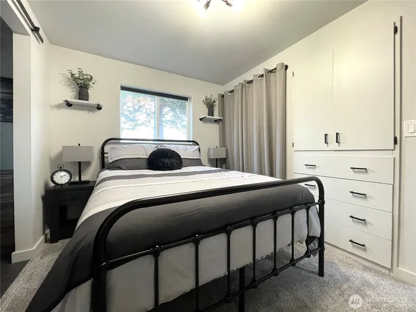 a bedroom with a bed and a window