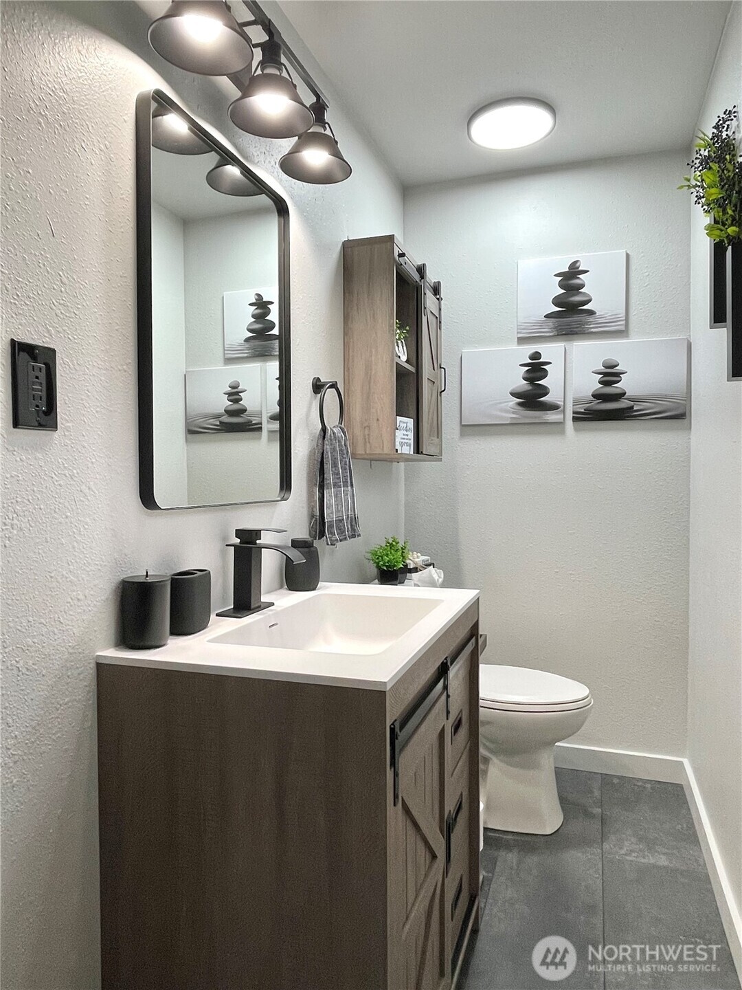 1180 4th Avenue North Okanogan, WA 98840 - Photo 27 of 40 a bathroom with a sink a toilet and mirror