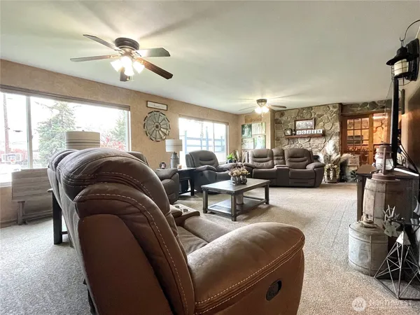 a living room with furniture and a chandelier