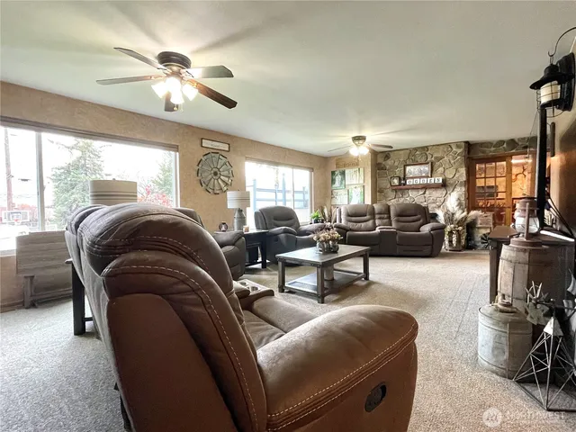 a living room with furniture and a chandelier
