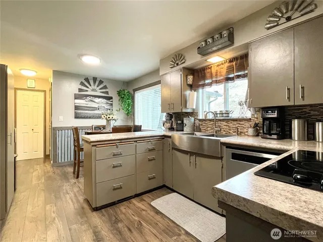 a kitchen with a sink stove and cabinets