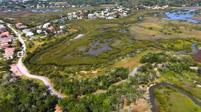 a front view of a house with a yard table and fire pit