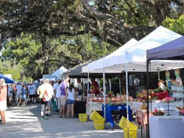 a view of ocean with boats and trees