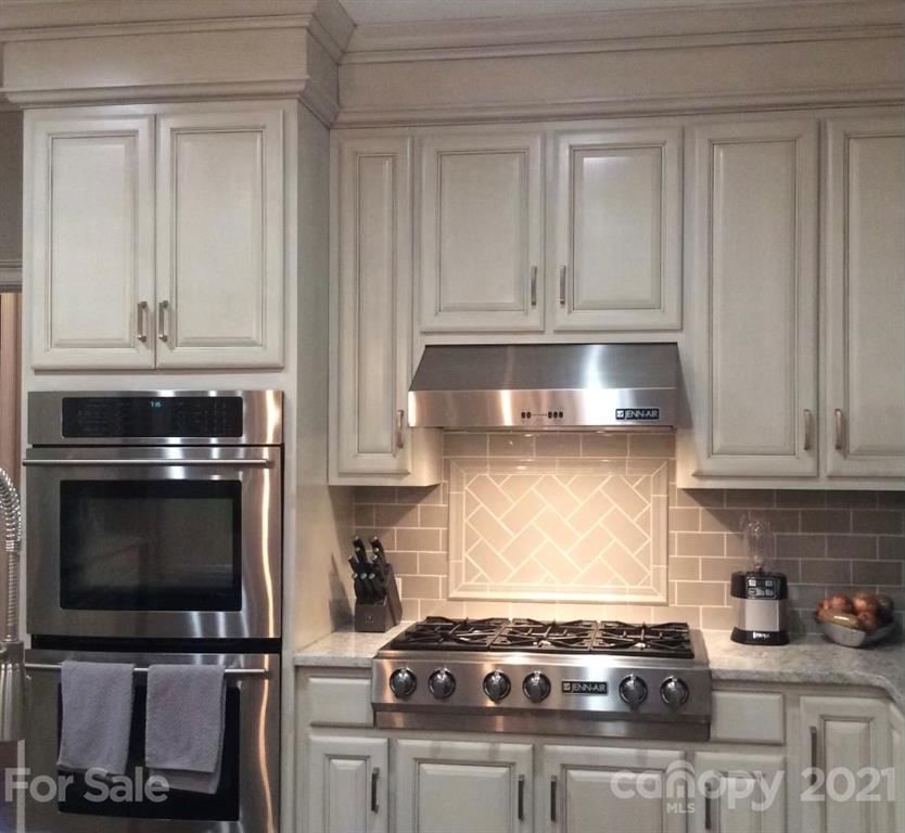 1600 Windy Ridge Road Charlotte, NC 28270 - Photo 3 of 9 a kitchen with granite countertop a stove and a microwave