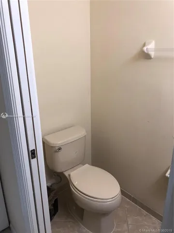 a white toilet sitting next to a sink