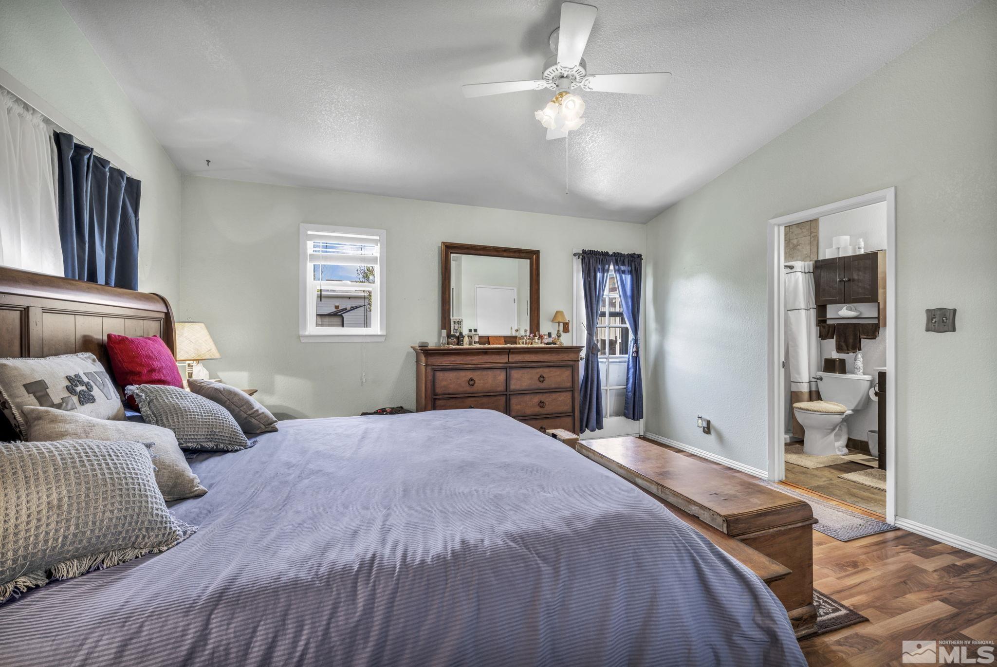 17575 Blackbird Drive Reno, NV 89508 - Photo 23 of 29 a bedroom with a large bed and a chandelier