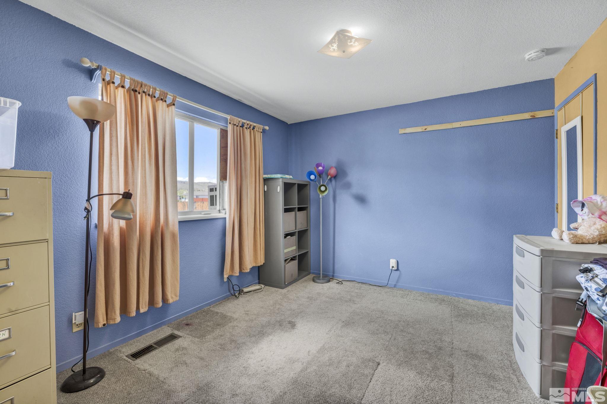 17575 Blackbird Drive Reno, NV 89508 - Photo 24 of 29 a view of an empty room with a fireplace