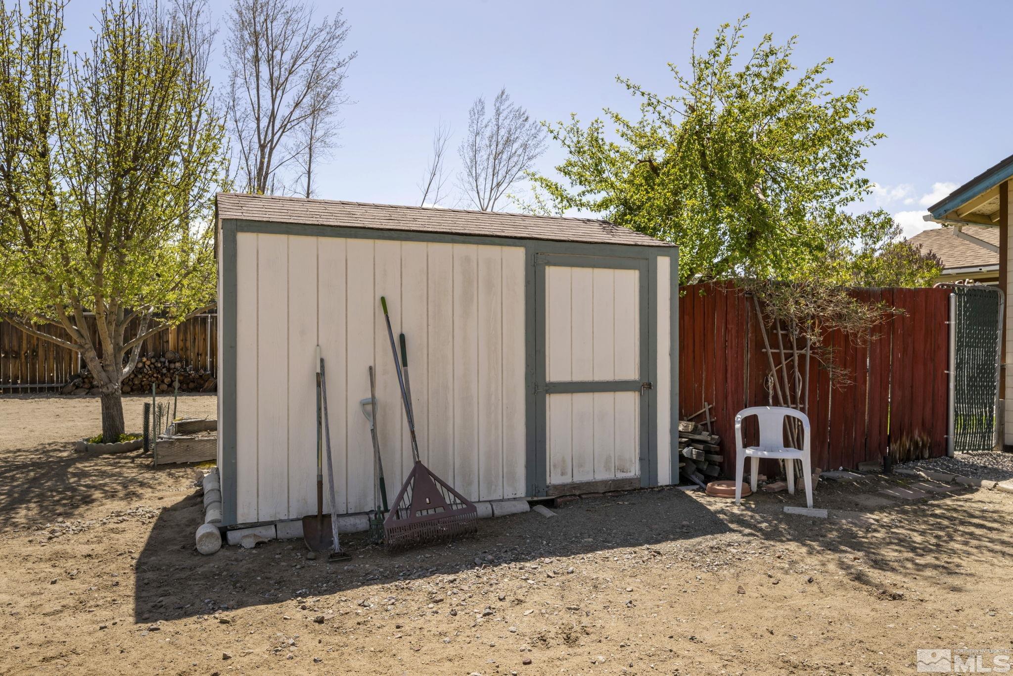 17575 Blackbird Drive Reno, NV 89508 - Photo 28 of 29 a lawn chairs sitting in a backyard with a wooden fence