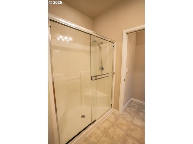a bathroom with a glass shower door
