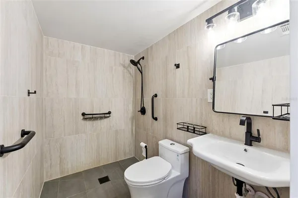 a bathroom with a sink toilet and shower