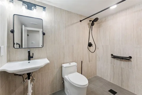 a bathroom with a sink toilet and shower
