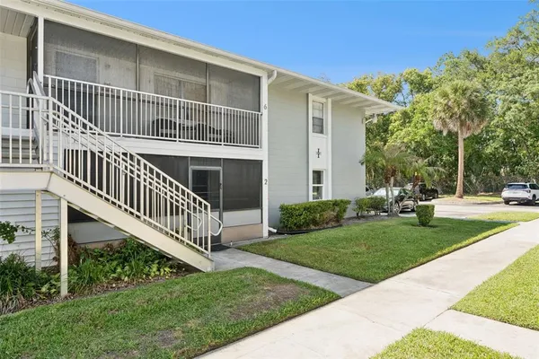 a view of a house with backyard and deck