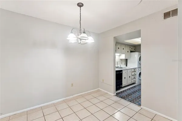 a view of a kitchen with white cabinets and sink