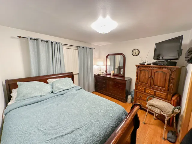 a bedroom with a bed and flat screen tv