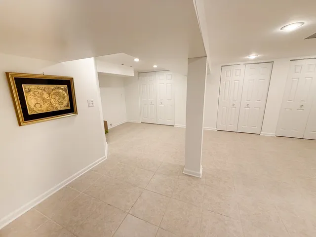 a view of an empty room with a painting