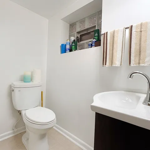 a white toilet sitting next to a bathroom sink