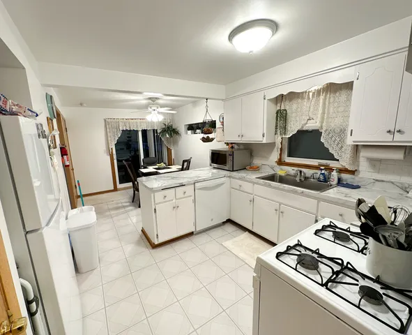 a kitchen with a sink appliances and cabinets