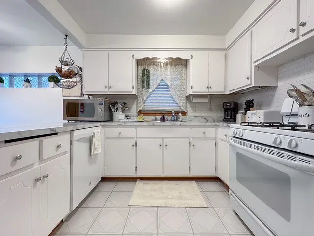 a kitchen with cabinets and window