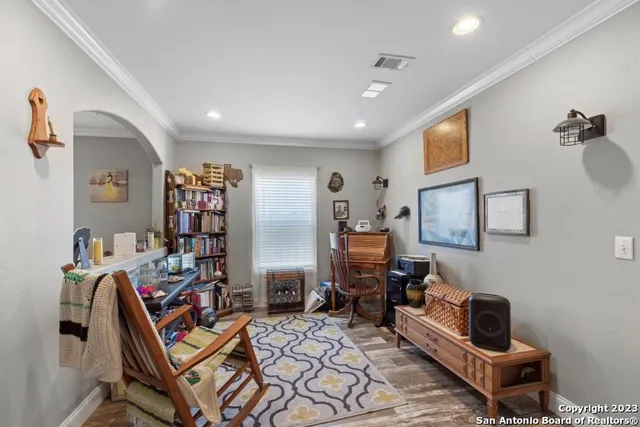 a room with furniture a flat screen tv and gym equipment