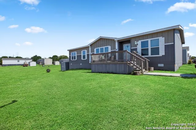 a front view of house with a garden