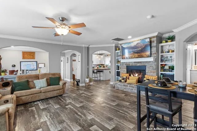 a living room with furniture and a fireplace
