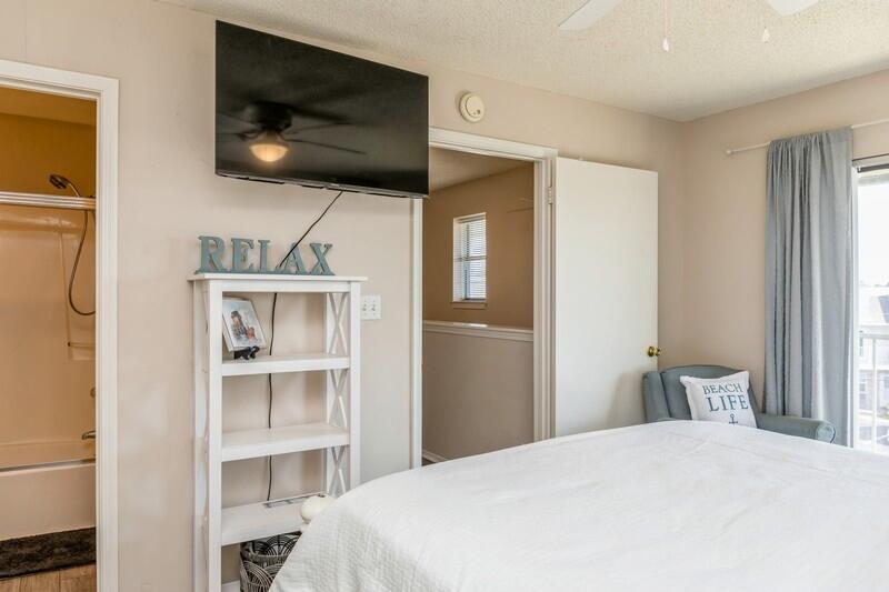 60 Sandprints Drive, Unit D2 Miramar Beach, FL 32550 - Photo 16 of 26 a bedroom with a bed and a flat screen tv