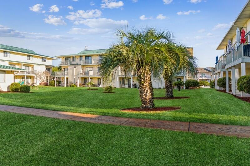 60 Sandprints Drive, Unit D2 Miramar Beach, FL 32550 - Photo 26 of 26 a view of a big building with a big yard and palm trees