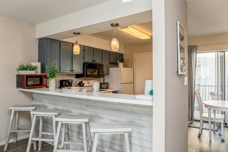 60 Sandprints Drive, Unit D2 Miramar Beach, FL 32550 - Photo 5 of 26 a kitchen with stainless steel appliances granite countertop a stove a sink and a microwave