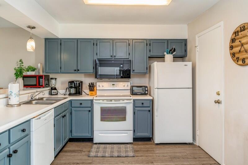 60 Sandprints Drive, Unit D2 Miramar Beach, FL 32550 - Photo 6 of 26 a kitchen with a sink a refrigerator and a stove