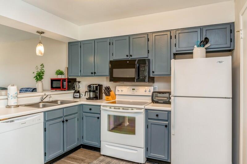 60 Sandprints Drive, Unit D2 Miramar Beach, FL 32550 - Photo 7 of 26 a kitchen with appliances a sink and lots of white cabinets